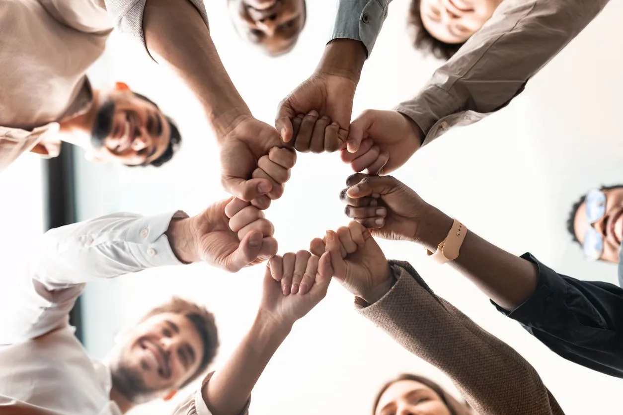 Portrait-of-diverse-business-people-giving-fist-bump-in-cirle-stock-photo